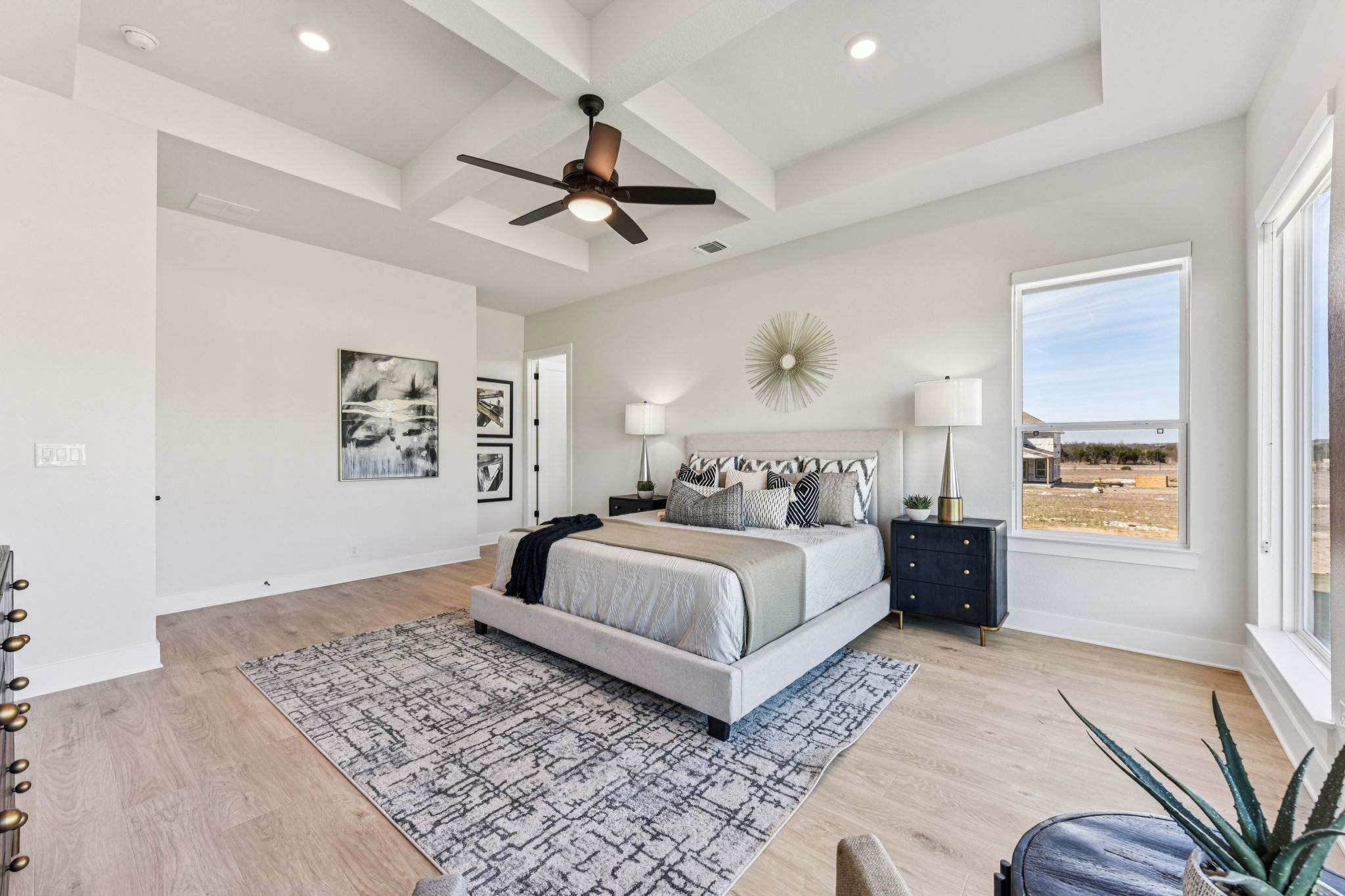208 Winters Cove Georgetown, TX 78633 - Photo 22 of 37 a bedroom with a large bed and a chandelier