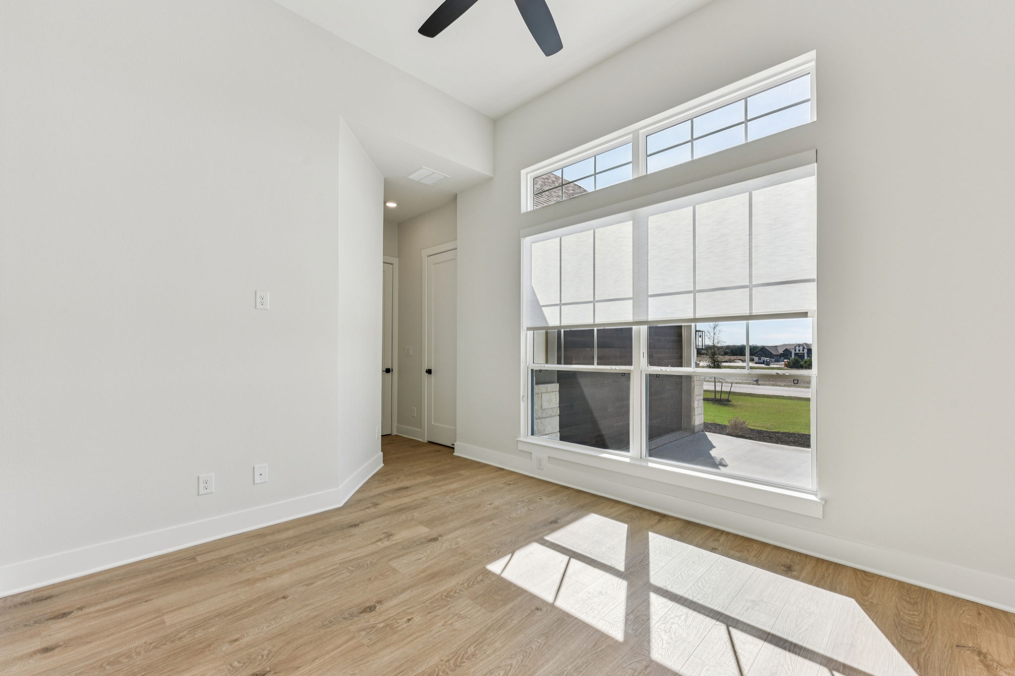208 Winters Cove Georgetown, TX 78633 - Photo 34 of 37 a view of an empty room with a window and wooden floor