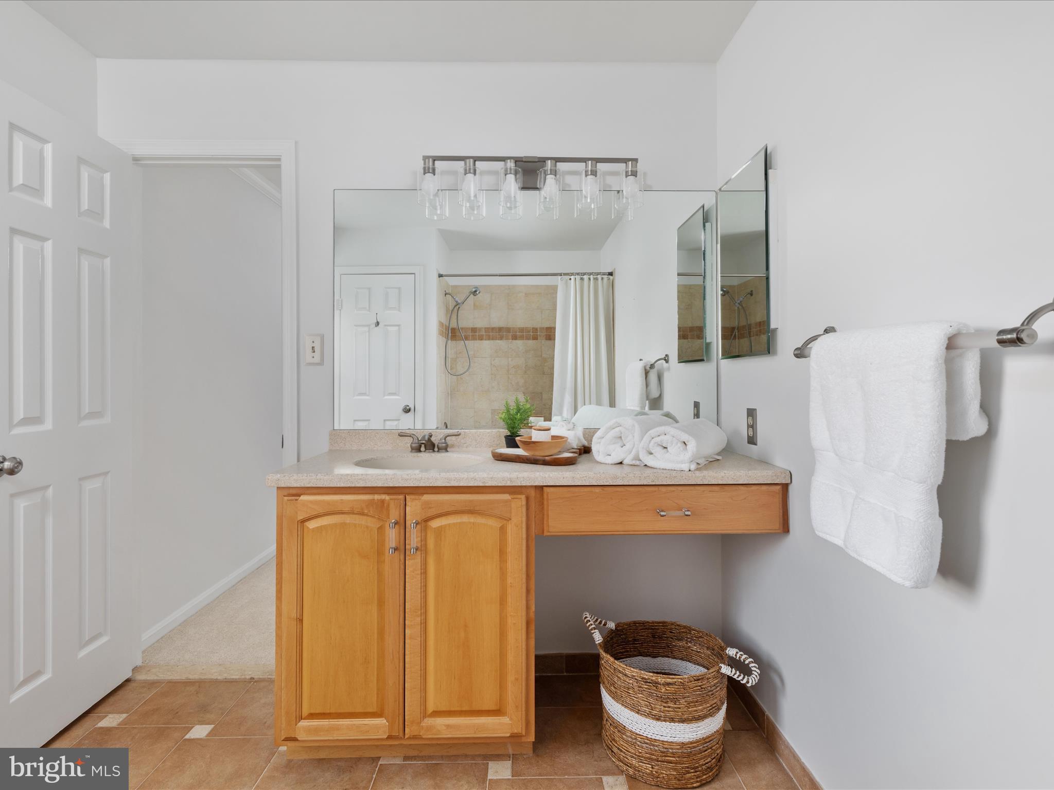10821 Cross School Road Reston, VA 20191 - Photo 23 of 50 a bathroom with a sink and a mirror