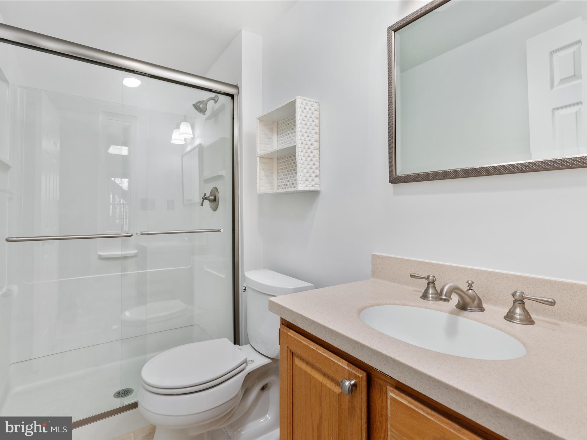 10821 Cross School Road Reston, VA 20191 - Photo 36 of 50 a bathroom with a granite countertop sink toilet and shower