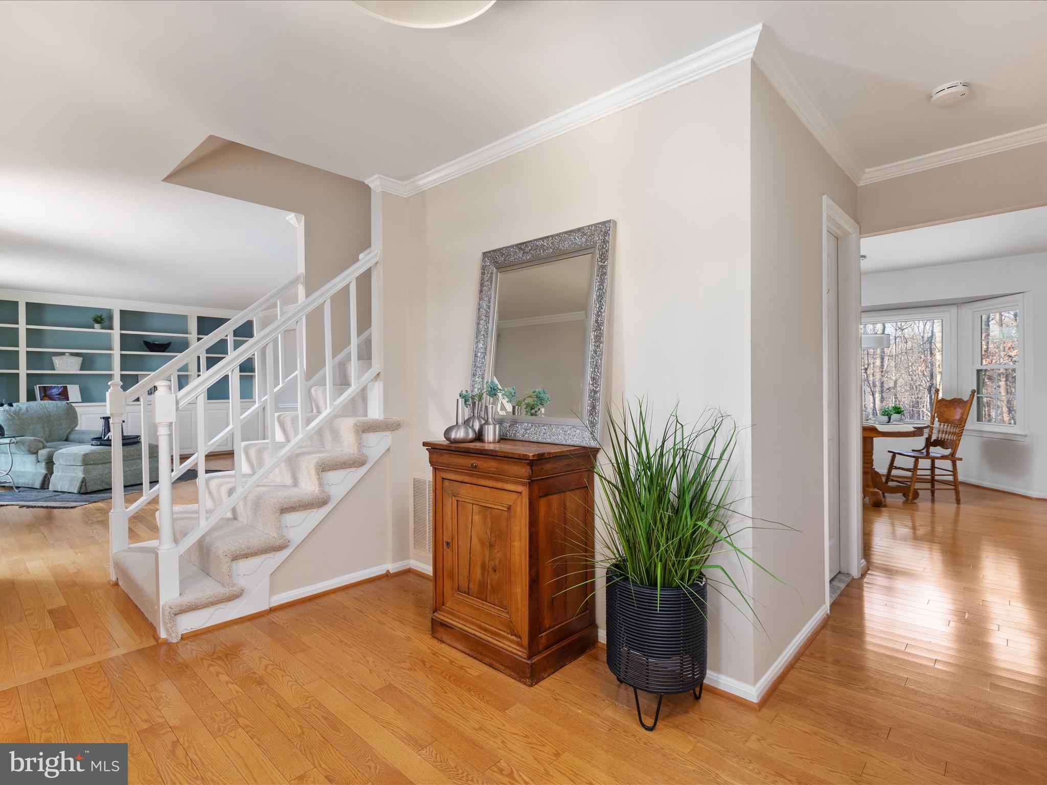 10821 Cross School Road Reston, VA 20191 - Photo 4 of 50 a view of a hallway with wooden floor and a potted plant
