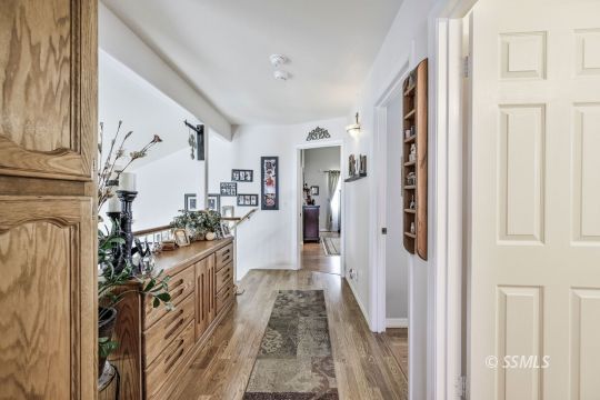 1213 Andrea Court Ridgecrest, CA 93555 - Photo 40 of 50 a view of a hallway with wooden floor and staircase