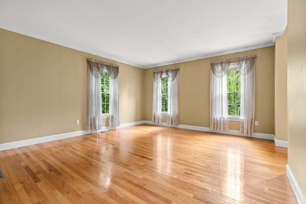 122 Depot Road Boxford, MA 01921 - Photo 11 of 41 a view of an empty room with wooden floor and a window