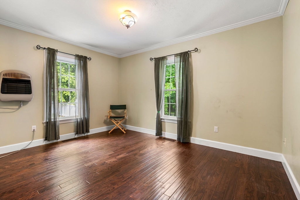 122 Depot Road Boxford, MA 01921 - Photo 13 of 41 a view of an empty room with a window and wooden floor