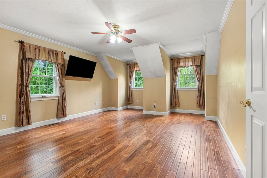 122 Depot Road Boxford, MA 01921 - Photo 20 of 41 a view of empty room with wooden floor and fan