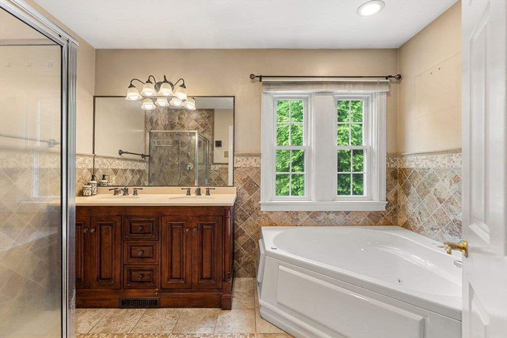 122 Depot Road Boxford, MA 01921 - Photo 21 of 41 a spacious bathroom with a granite countertop sink mirror and a bathtub