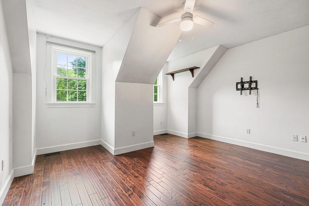 122 Depot Road Boxford, MA 01921 - Photo 23 of 41 an empty room with wooden floor and windows