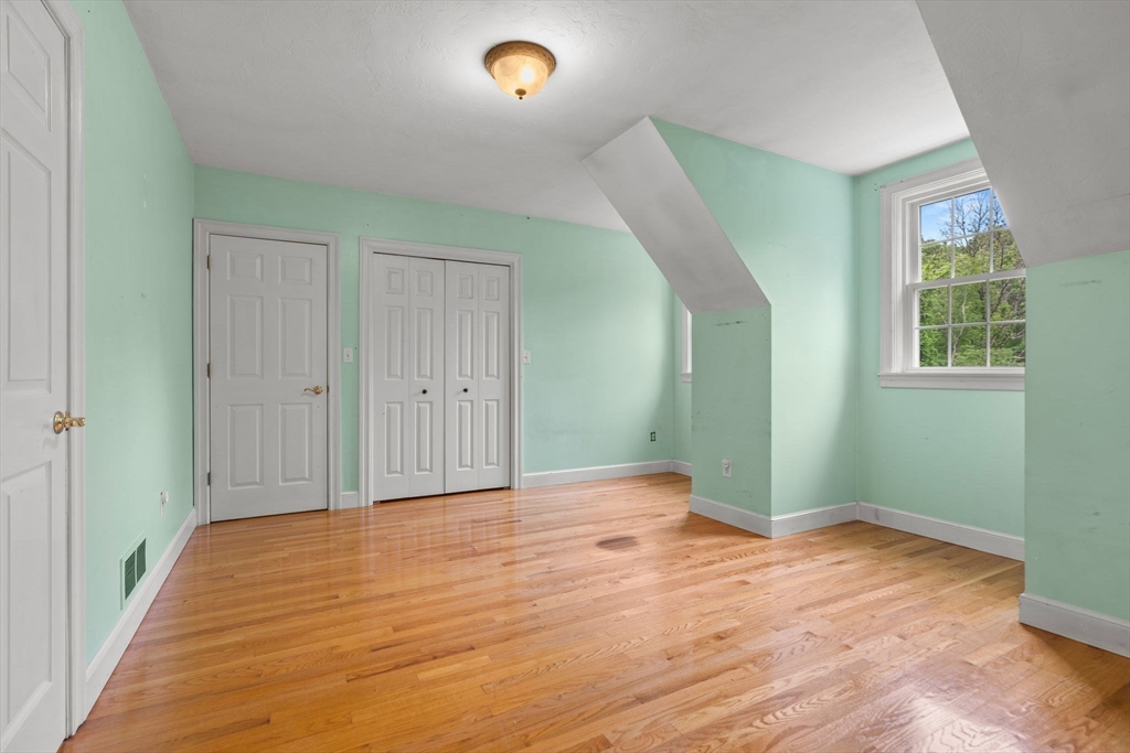 122 Depot Road Boxford, MA 01921 - Photo 26 of 41 a view of an empty room with wooden floor and a window