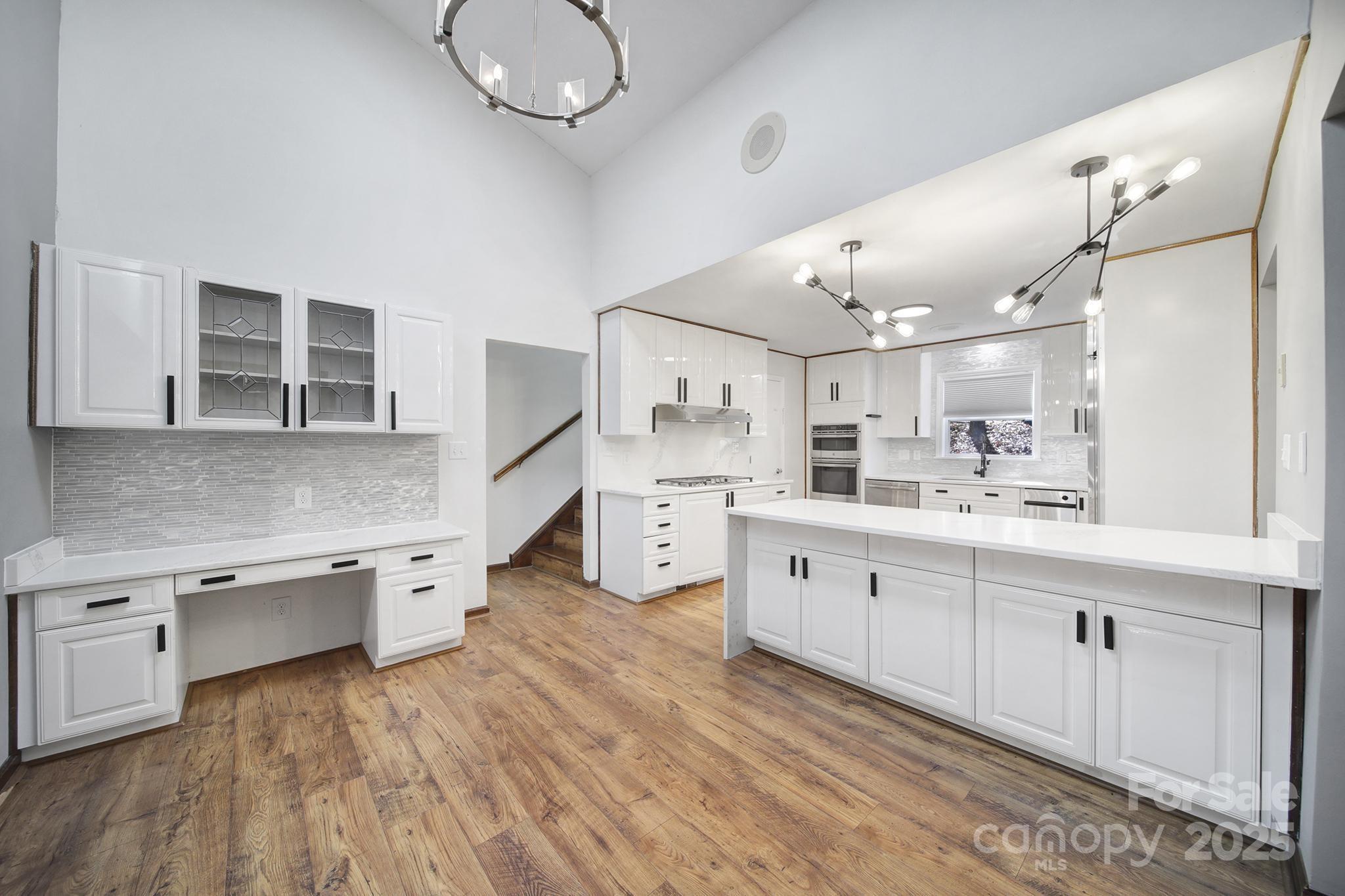 7005 Tega Cay Drive Tega Cay, SC 29708 - Photo 14 of 48 a kitchen with stainless steel appliances granite countertop a lot of counter space and wooden floors