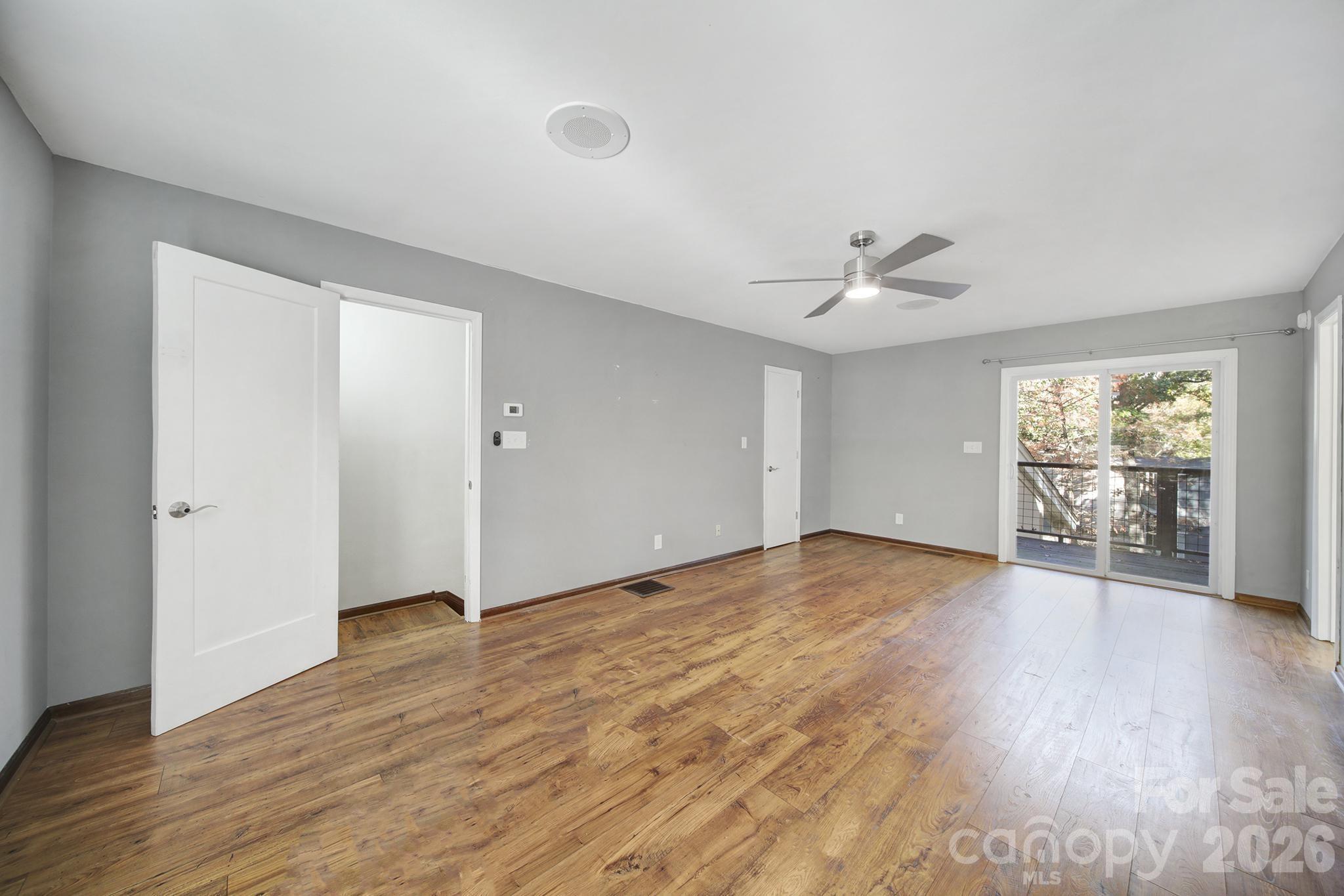 7005 Tega Cay Drive Tega Cay, SC 29708 - Photo 17 of 48 an empty room with wooden floor and windows