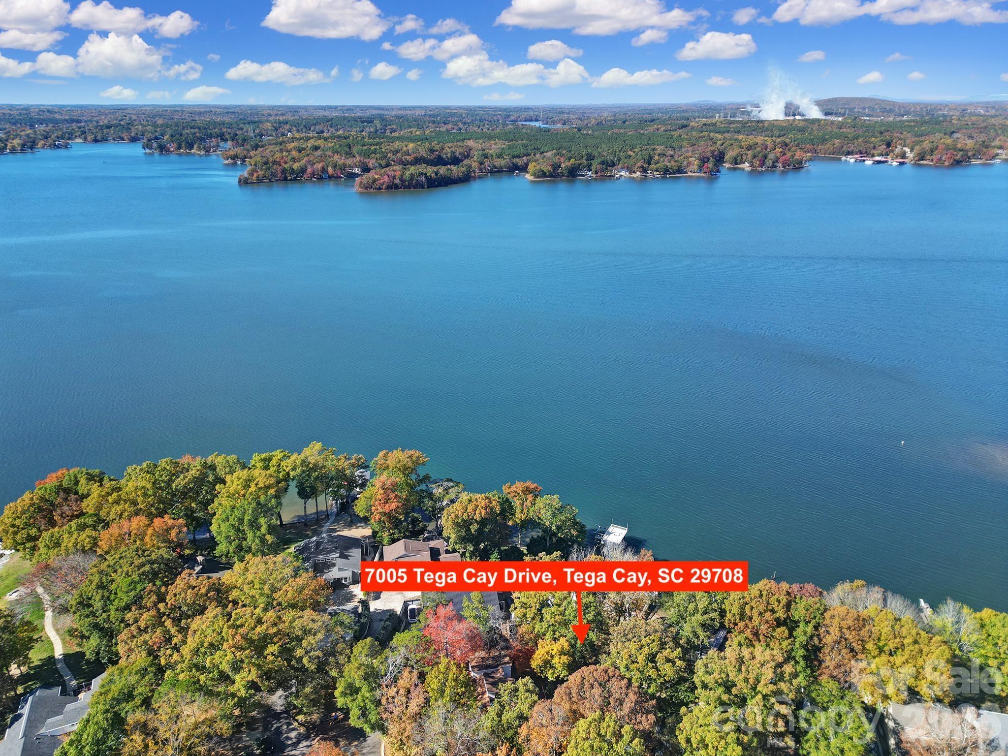 7005 Tega Cay Drive Tega Cay, SC 29708 - Photo 2 of 48 a view of a lake in middle of forest