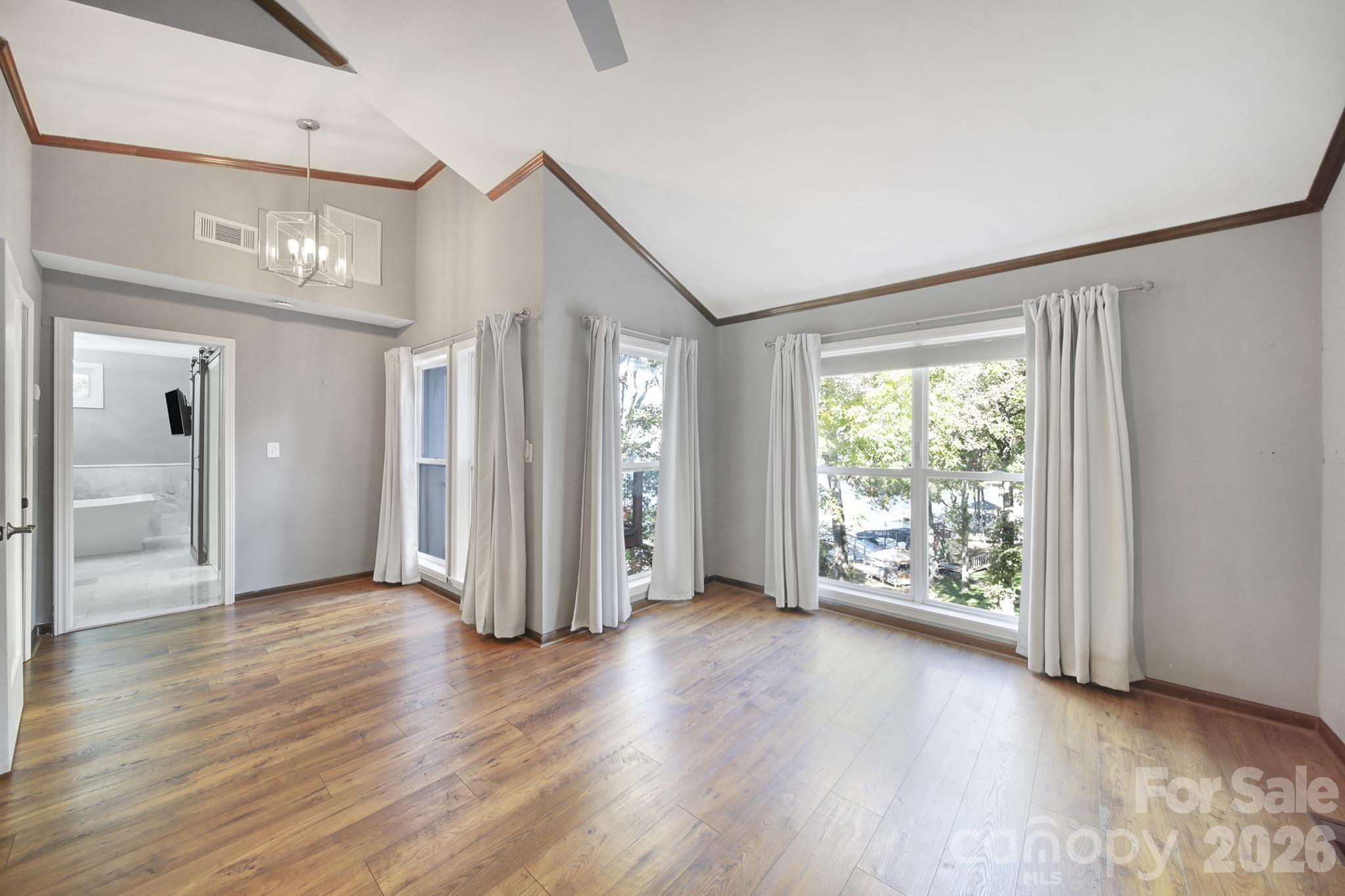 7005 Tega Cay Drive Tega Cay, SC 29708 - Photo 23 of 48 a view of an empty room with wooden floor and a window