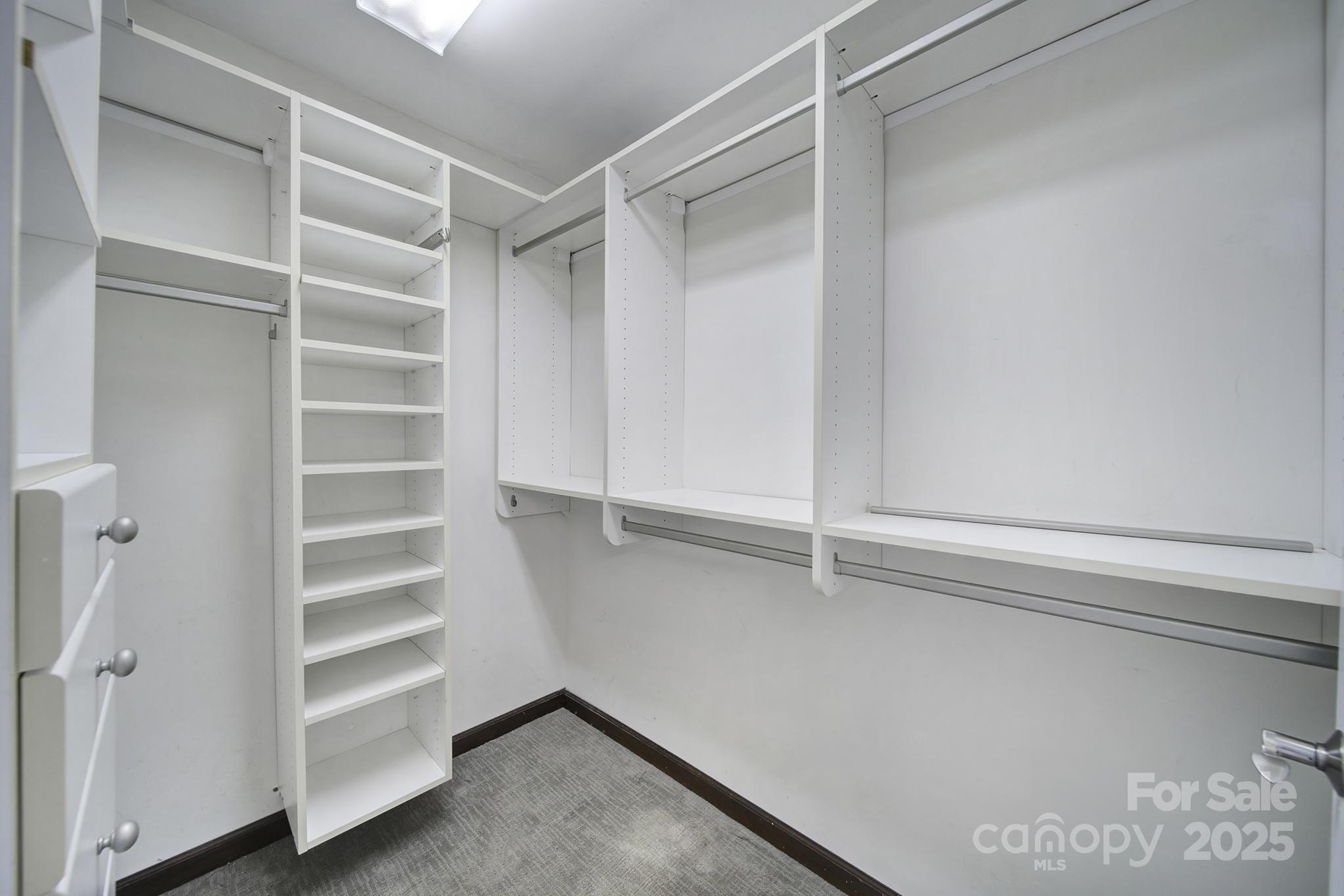 7005 Tega Cay Drive Tega Cay, SC 29708 - Photo 23 of 48 a view of walk in closet with empty racks