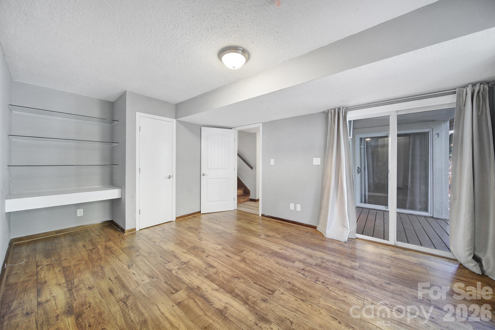 7005 Tega Cay Drive Tega Cay, SC 29708 - Photo 31 of 48 wooden floor in an empty room with a closet