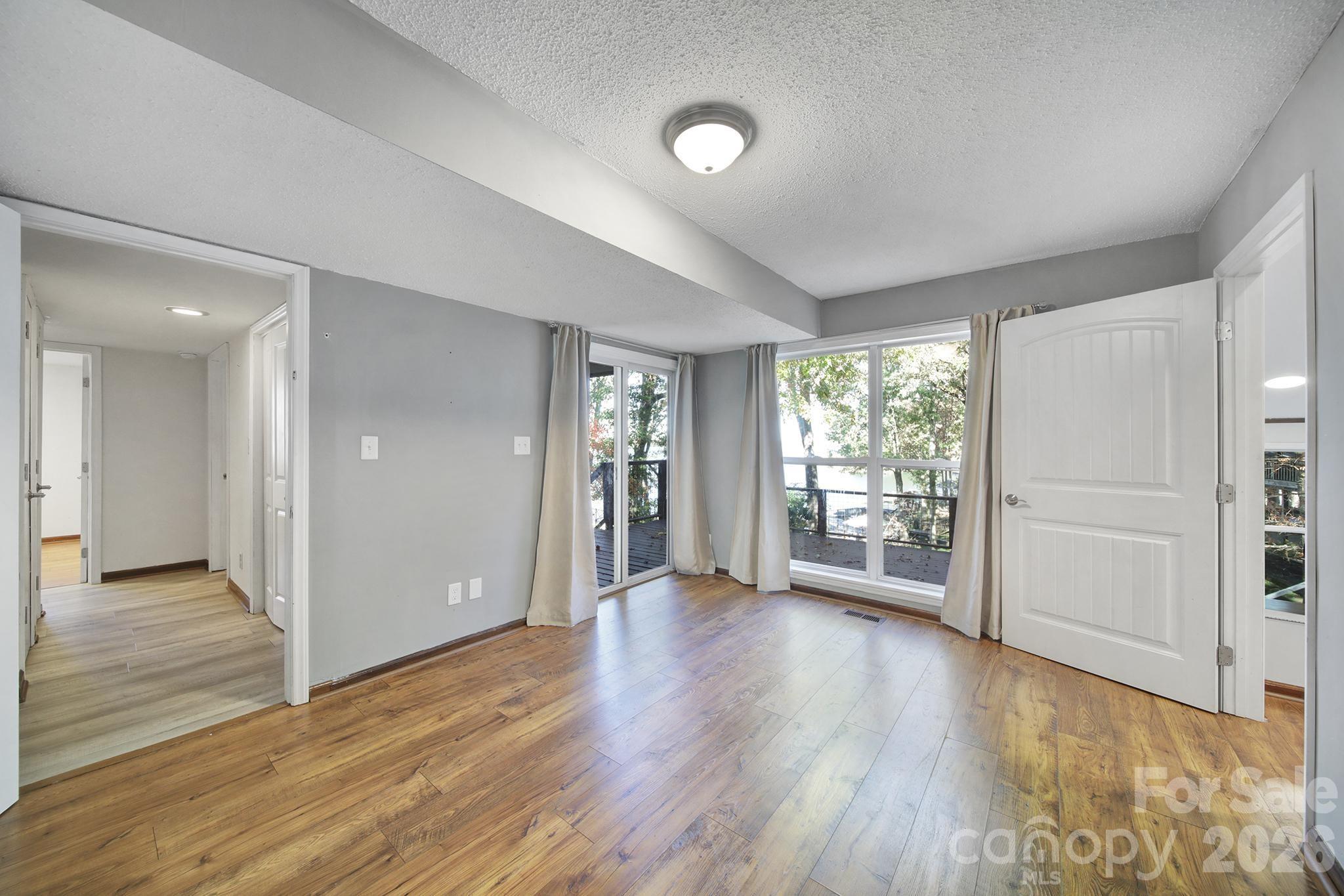 7005 Tega Cay Drive Tega Cay, SC 29708 - Photo 32 of 48 wooden floor in an empty room with a window