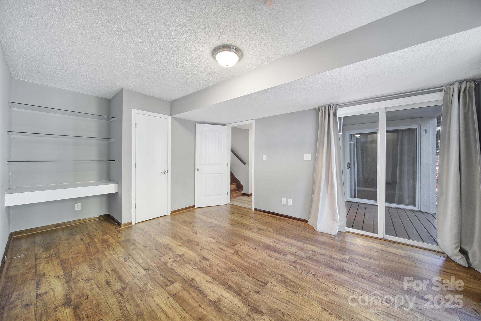 7005 Tega Cay Drive Tega Cay, SC 29708 - Photo 34 of 48 wooden floor in an empty room with a closet