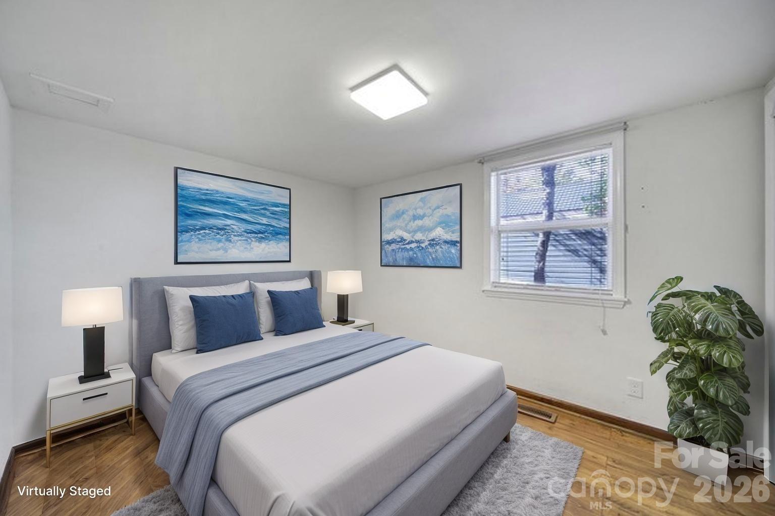 7005 Tega Cay Drive Tega Cay, SC 29708 - Photo 35 of 48 a bedroom with a bed and a potted plant