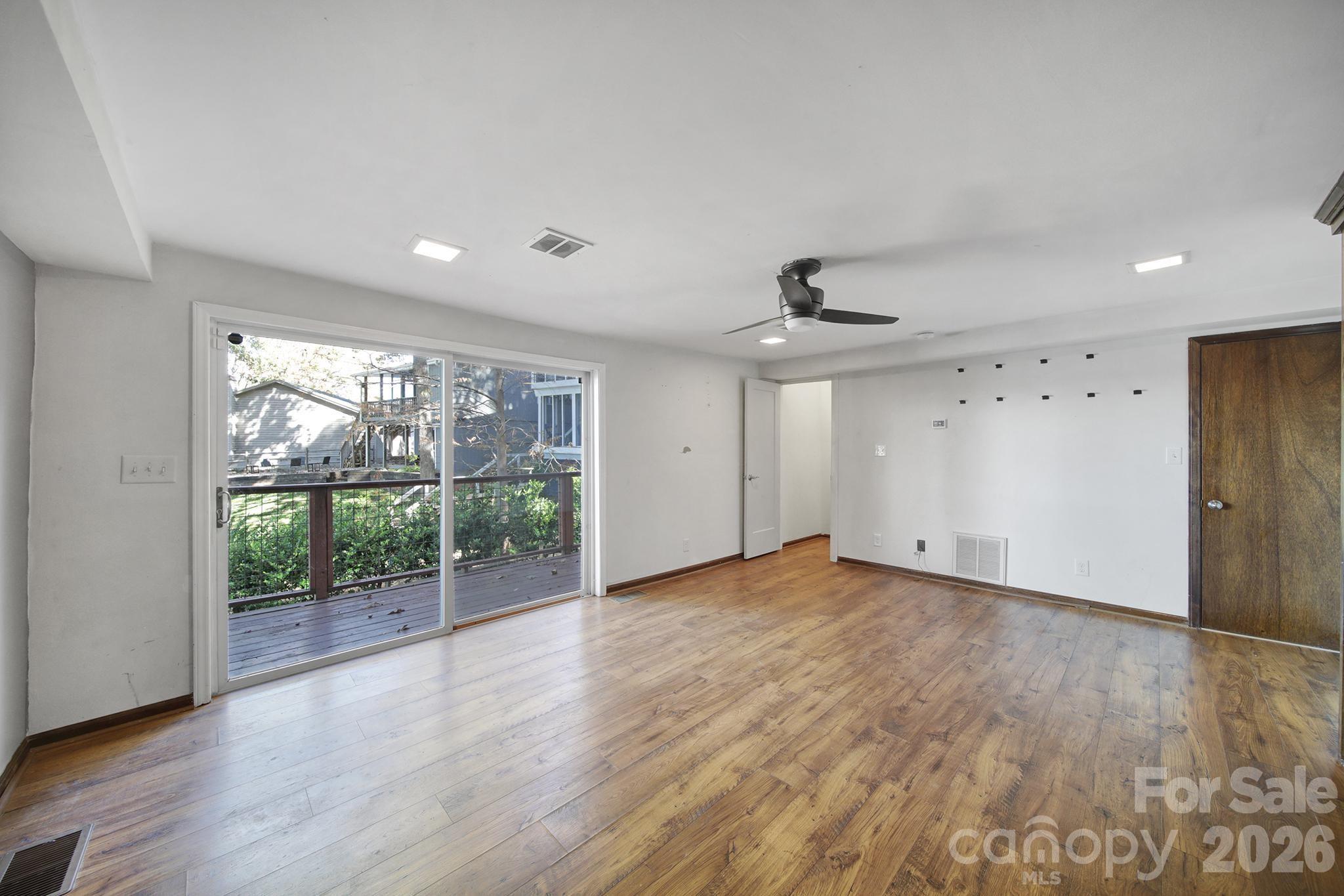 7005 Tega Cay Drive Tega Cay, SC 29708 - Photo 42 of 48 a view of an empty room with wooden floor and a window