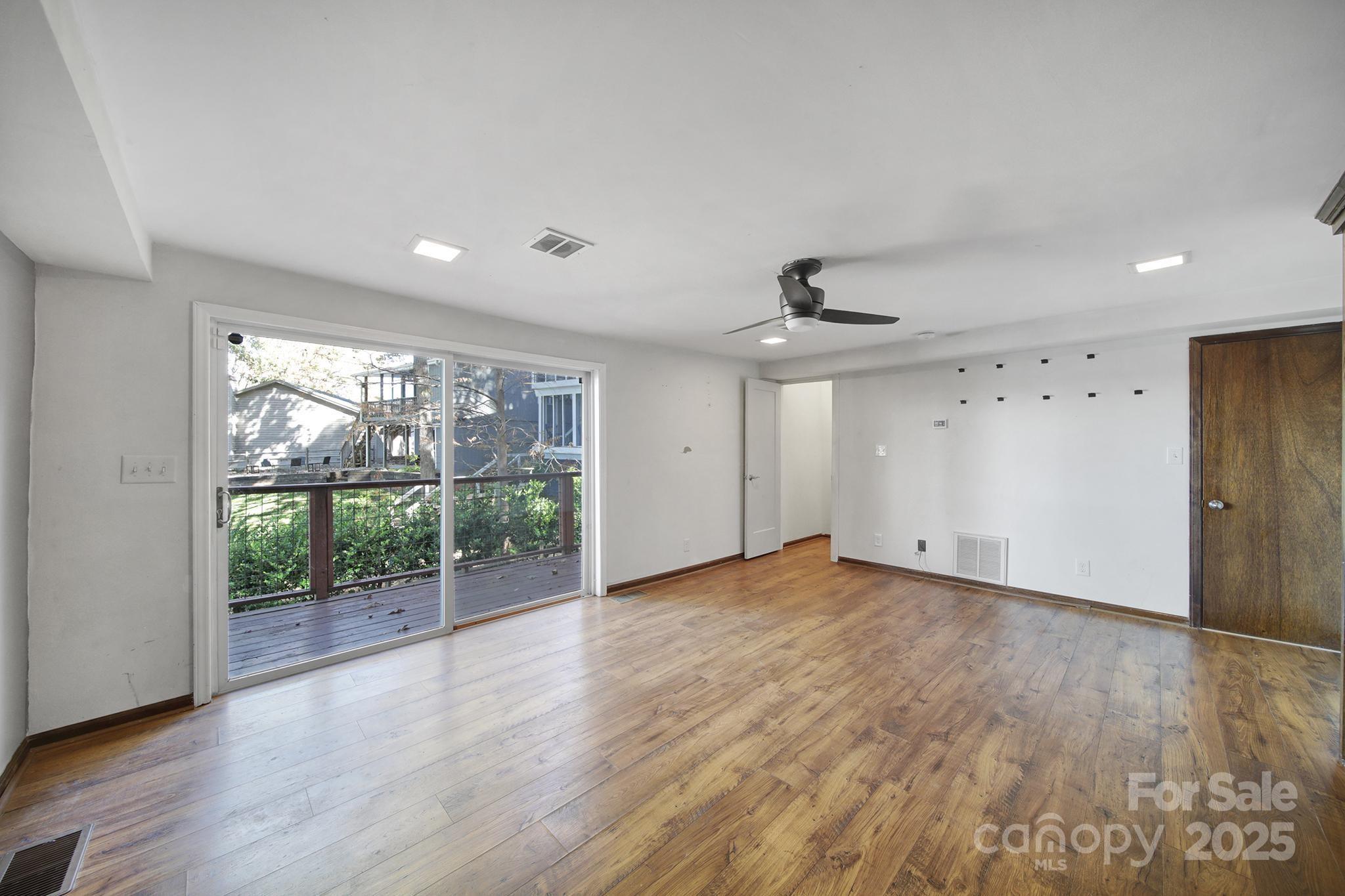 7005 Tega Cay Drive Tega Cay, SC 29708 - Photo 45 of 48 a view of an empty room with wooden floor and a window