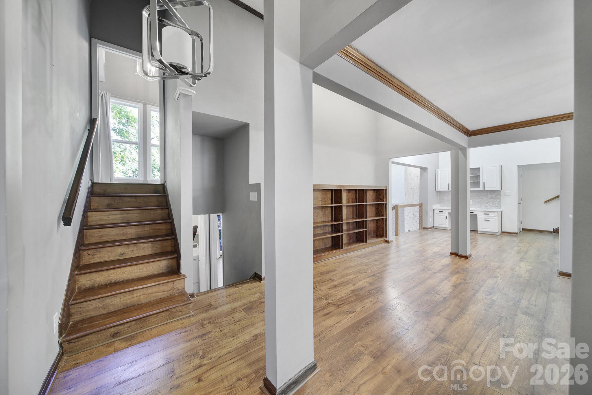 7005 Tega Cay Drive Tega Cay, SC 29708 - Photo 7 of 48 a view of a living room with wooden floor and stairs