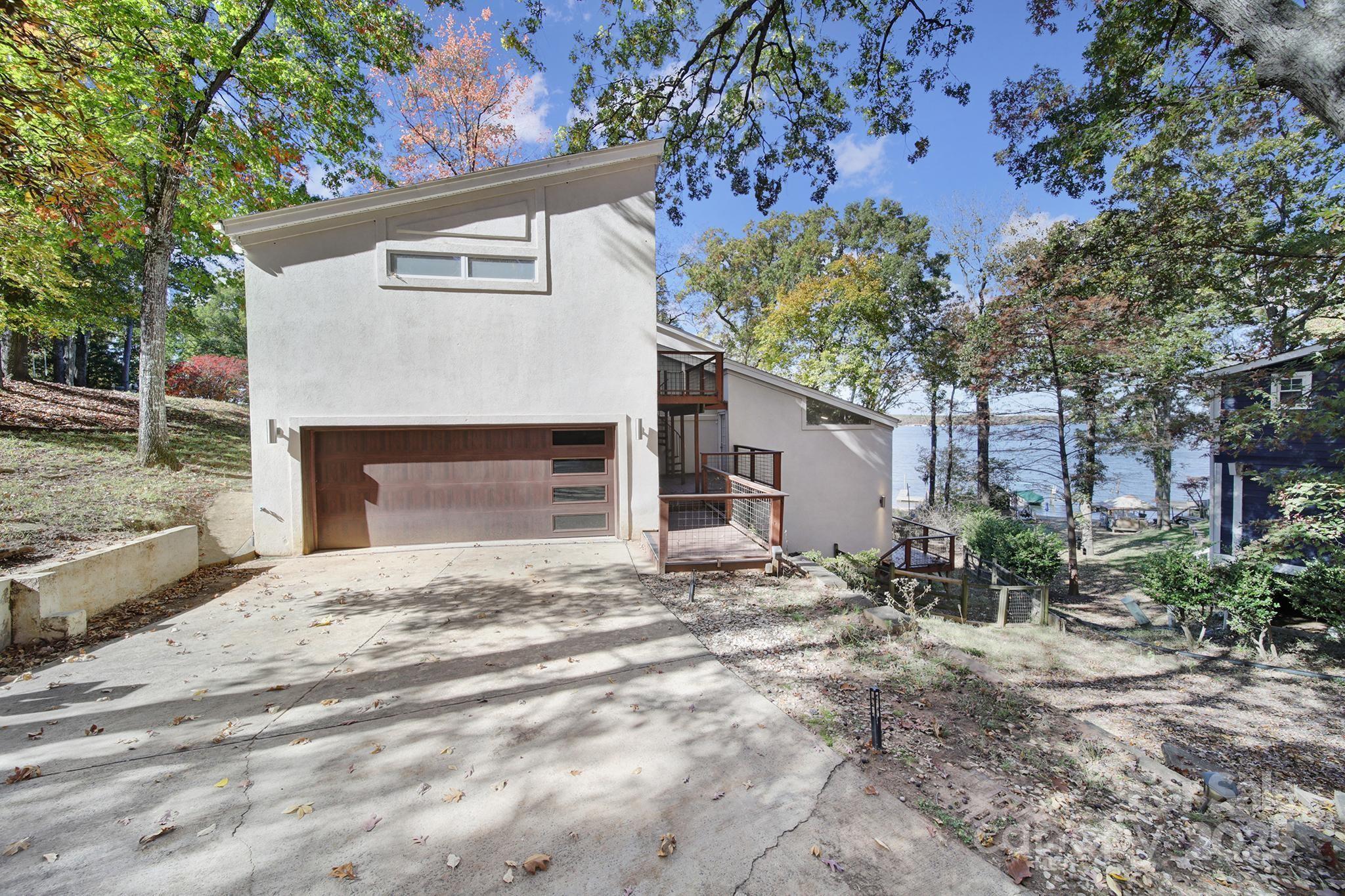 7005 Tega Cay Drive Tega Cay, SC 29708 - Photo 7 of 48 a front view of a house with a yard and garage