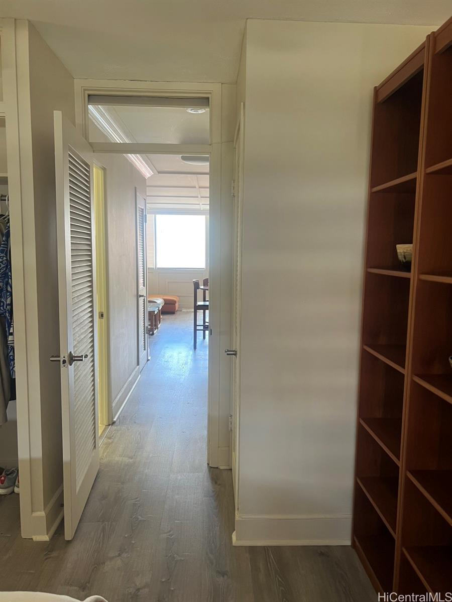 425 Ena Road, Unit B1002 Honolulu, HI 96815 - Photo 11 of 20 a view of a hallway with wooden shelves