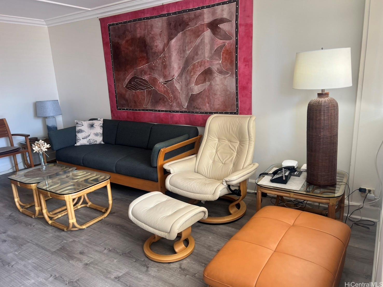 425 Ena Road, Unit B1002 Honolulu, HI 96815 - Photo 3 of 20 a living room with furniture a rug and wall paintings