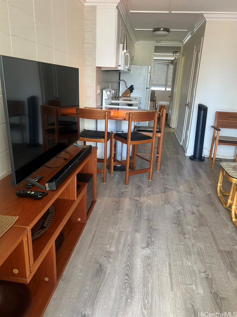 425 Ena Road, Unit B1002 Honolulu, HI 96815 - Photo 4 of 20 a room with wooden floor and furniture