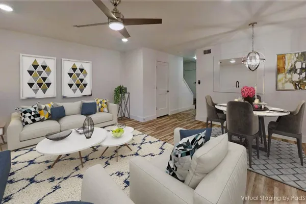 a living room with furniture and wooden floor