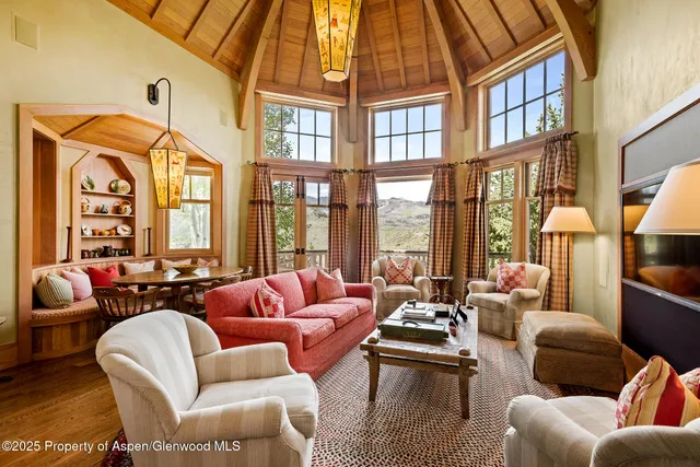 a kitchen with white cabinets and chandelier
