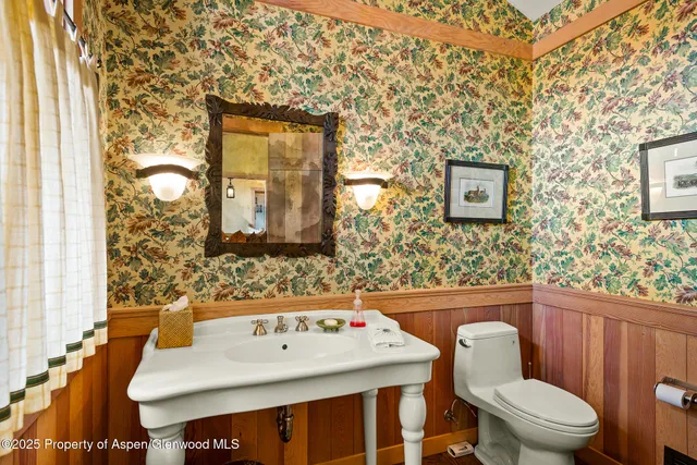 a bathroom with a tub a sink and a large mirror