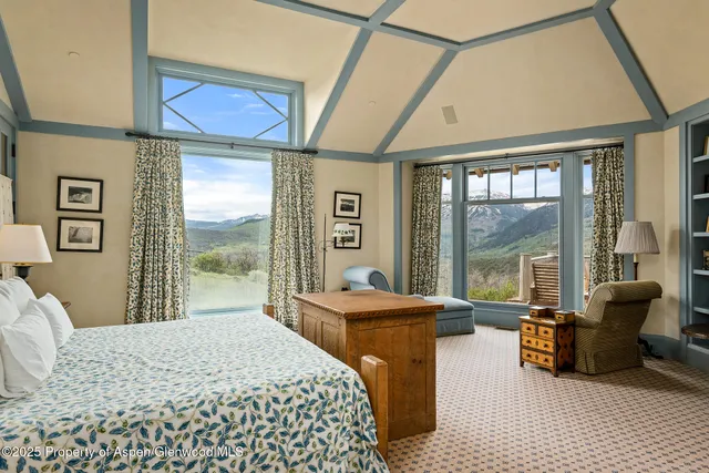 a spacious bedroom with a bed and a couch