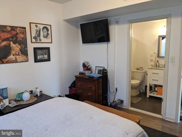 a bedroom with a bed and a television