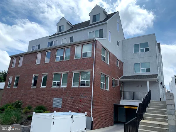 a front view of a building with many windows