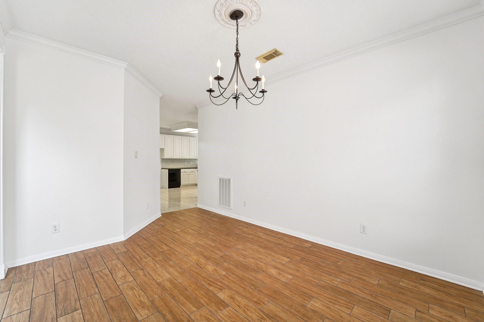 14420 Walters Road, Unit 55 Houston, TX 77014 - Photo 19 of 35 a view of a kitchen with wooden floor and a ceiling fan