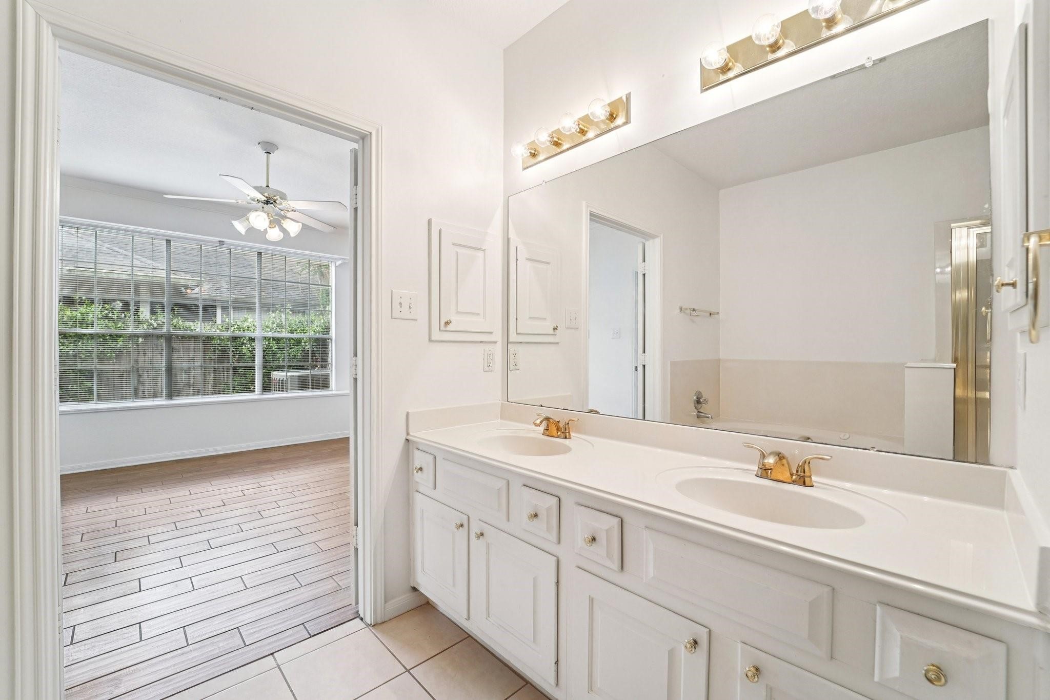 14420 Walters Road, Unit 55 Houston, TX 77014 - Photo 24 of 35 a spacious bathroom with a double vanity sink a mirror and a shower
