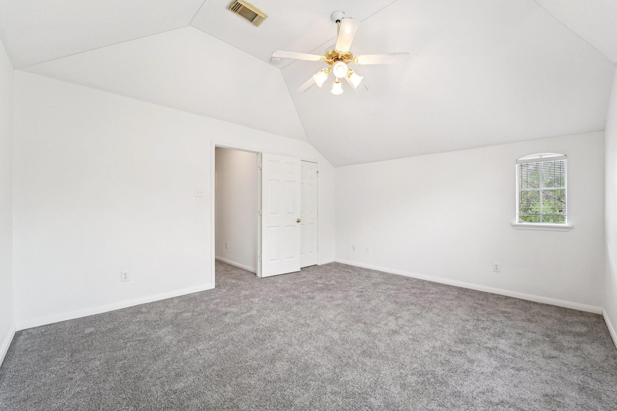 14420 Walters Road, Unit 55 Houston, TX 77014 - Photo 28 of 35 an empty room with a chandelier fan and windows