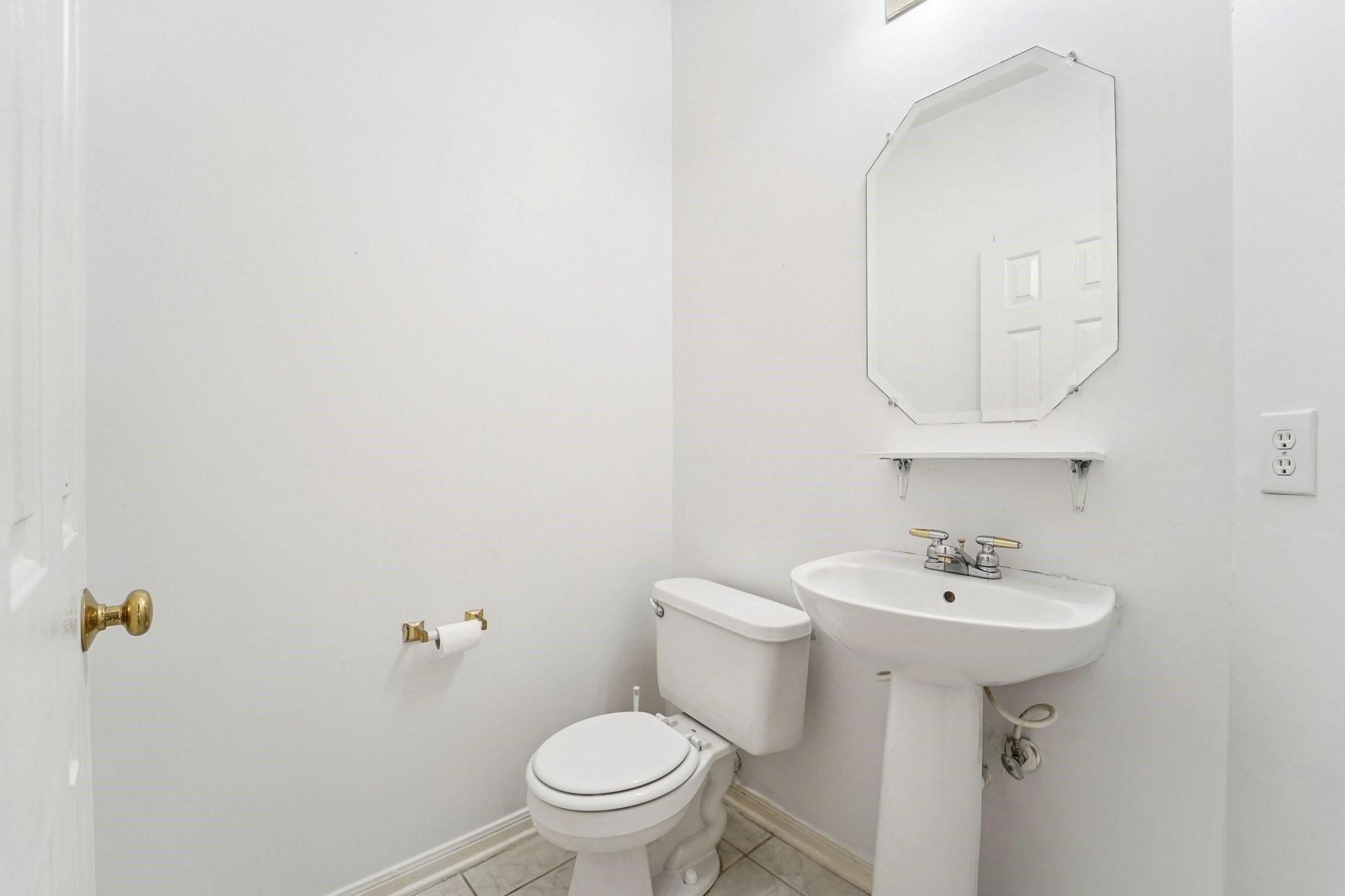 14420 Walters Road, Unit 55 Houston, TX 77014 - Photo 7 of 35 a bathroom with a sink a toilet and mirror