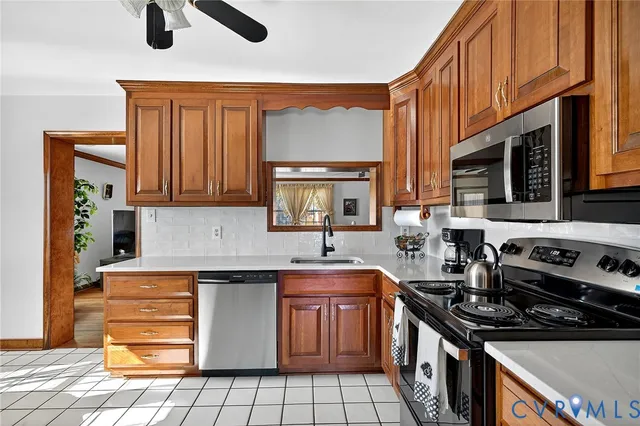 a kitchen with a sink stove top oven and cabinets