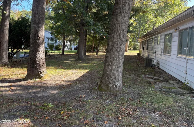 a view of a yard with trees