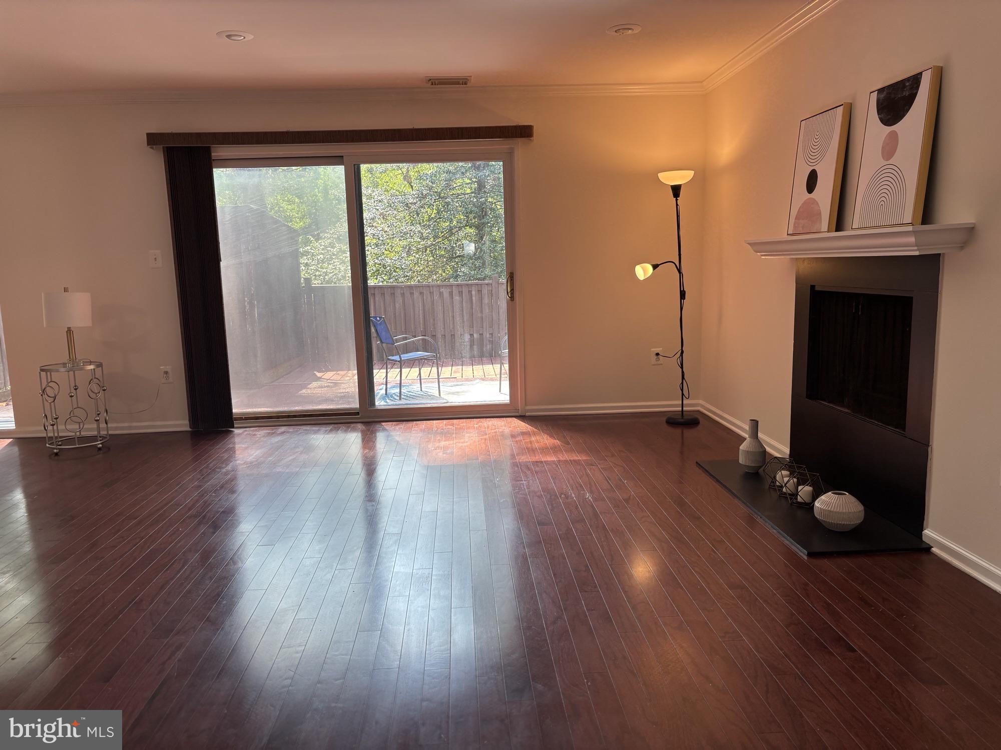 1833 Ivy Oak Square, Unit 49 Reston, VA 20190 - Photo 3 of 33 a view of an empty room with wooden floor and a window