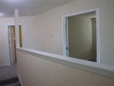 a view of room with a ceiling fan and window