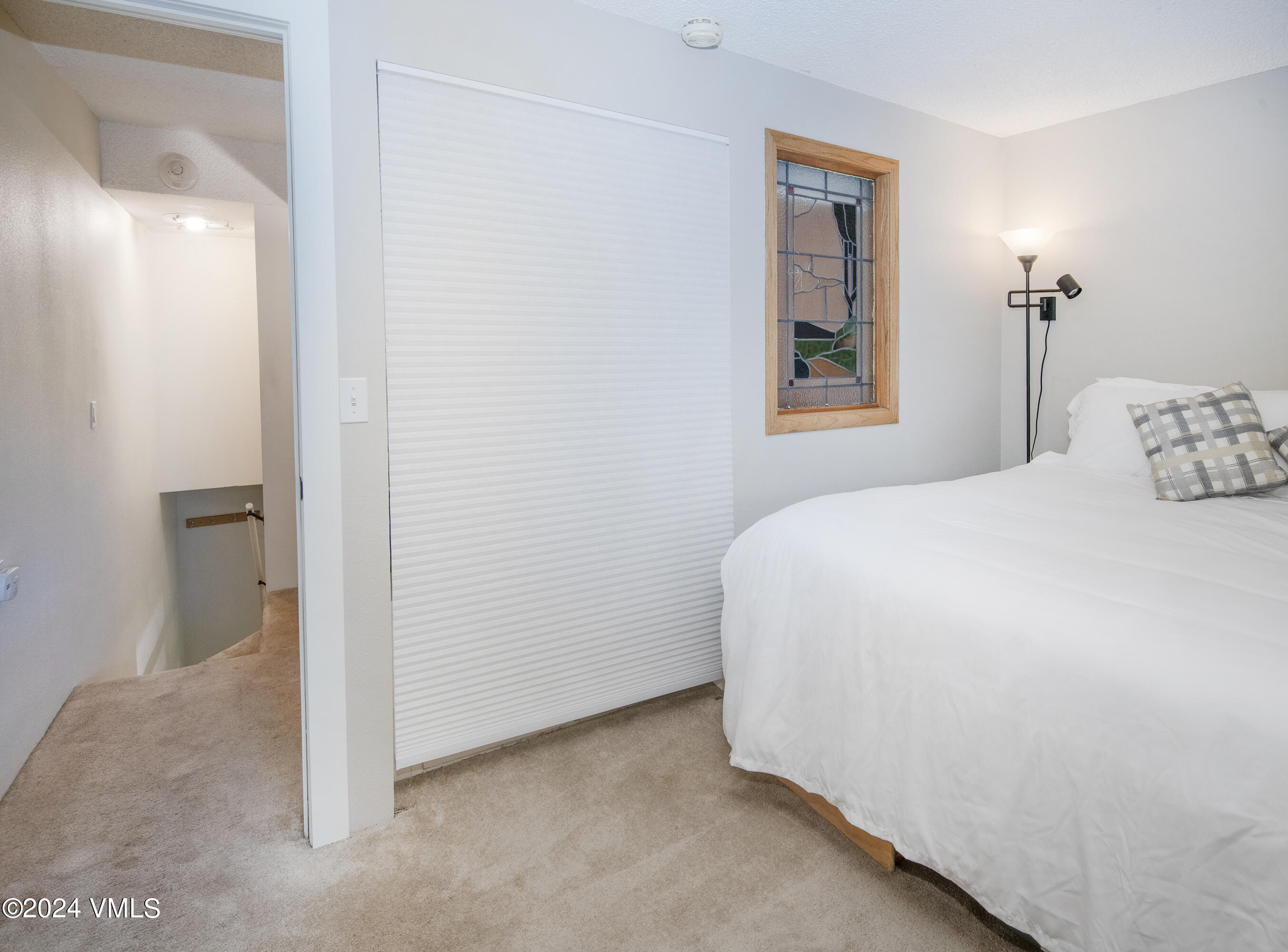 1081 Vail View Drive, Unit B208 Vail, CO 81657 - Photo 14 of 22 a bedroom with a bed and a window