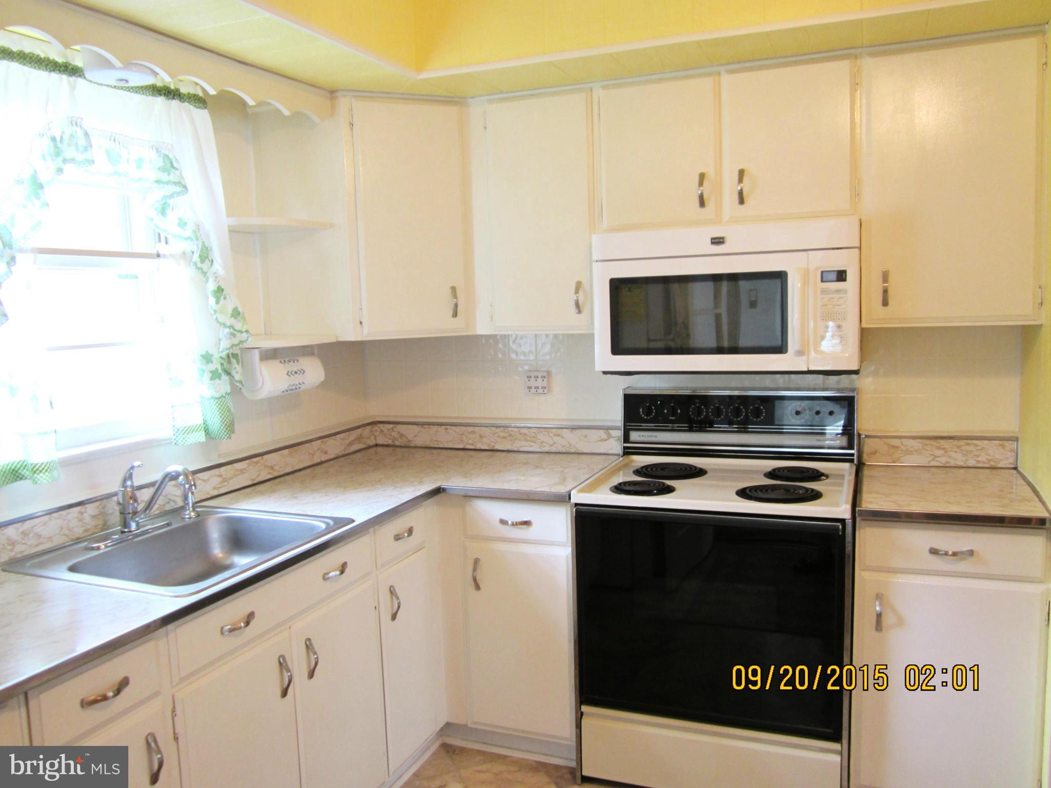 2890 Singerly Road Elkton, MD 21921 - Photo 11 of 28 a kitchen with stainless steel appliances granite countertop a sink a stove and a microwave