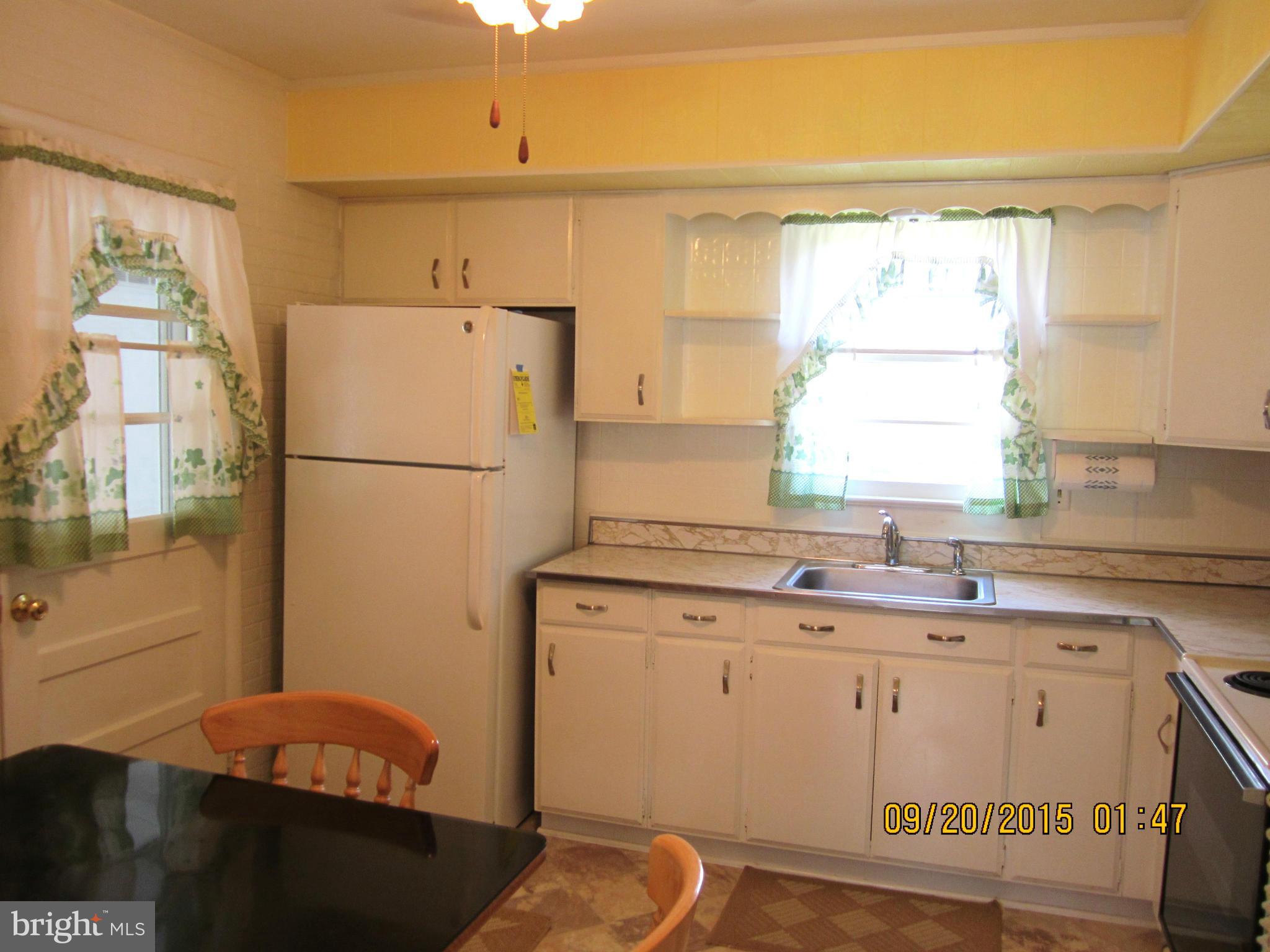 2890 Singerly Road Elkton, MD 21921 - Photo 12 of 28 a kitchen with a sink a refrigerator and window