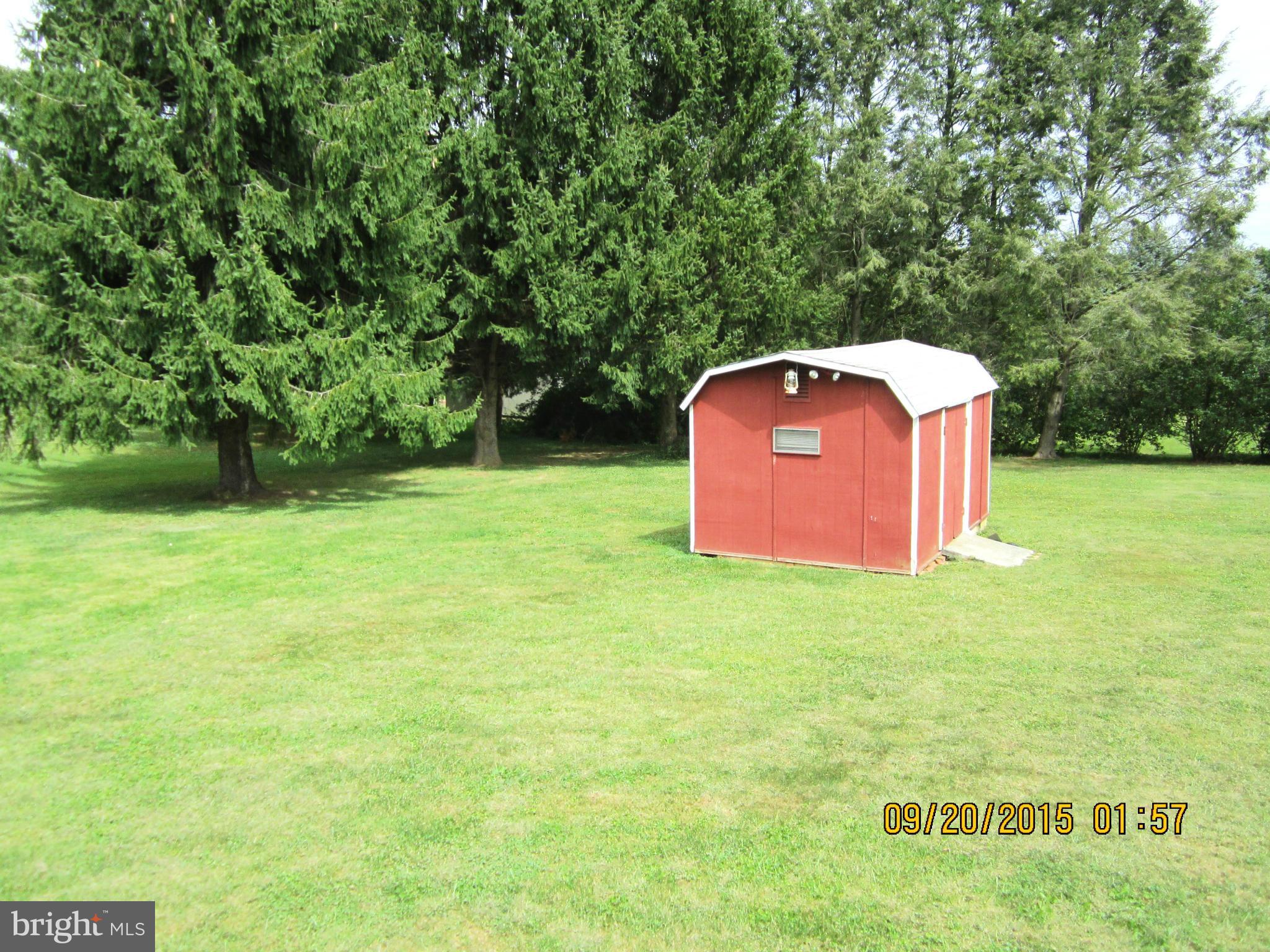 2890 Singerly Road Elkton, MD 21921 - Photo 7 of 28 a backyard of a house with yard and green space