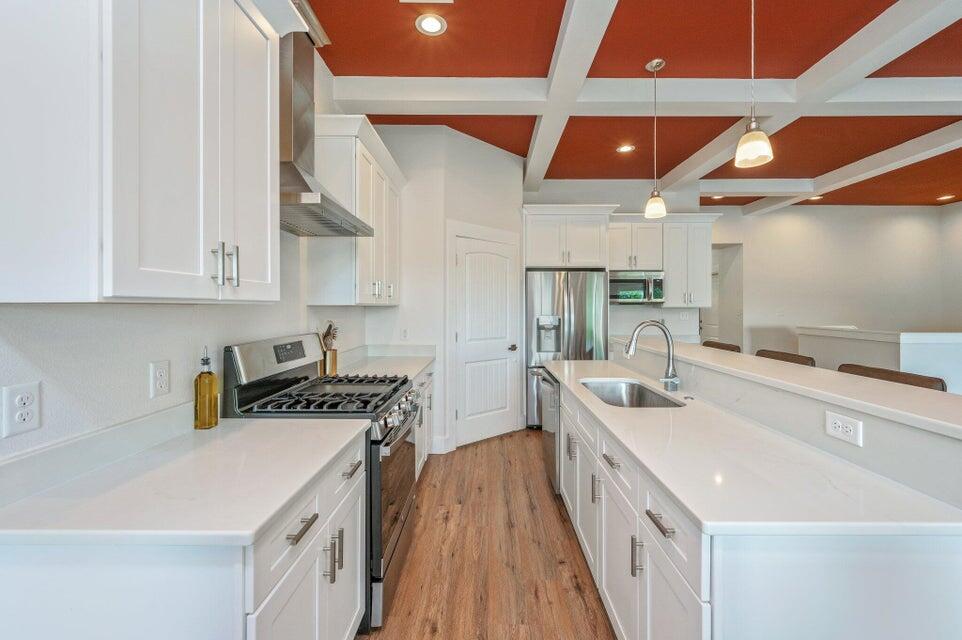 508 Harborview Circle Niceville, FL 32578 - Photo 15 of 60 a kitchen with stainless steel appliances a sink a stove and a wooden floors