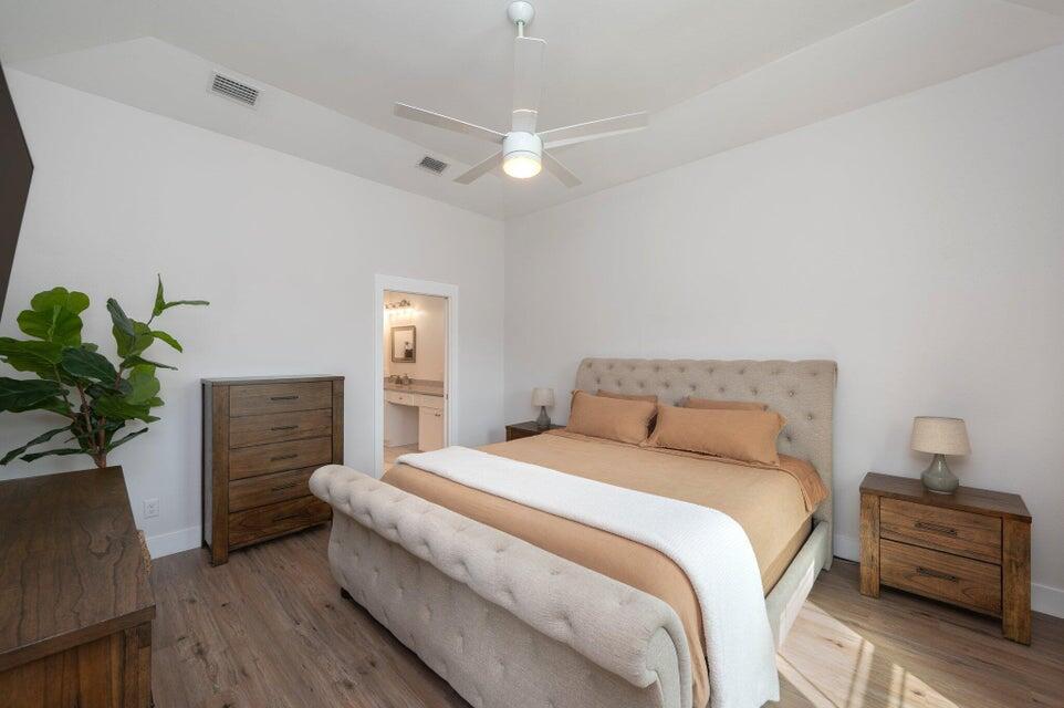 508 Harborview Circle Niceville, FL 32578 - Photo 20 of 60 a bedroom with a bed and a potted plant