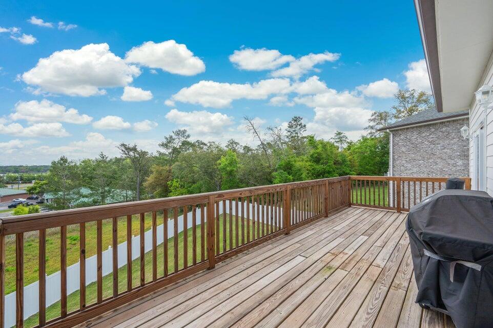508 Harborview Circle Niceville, FL 32578 - Photo 33 of 60 a balcony with wooden floor in front of it