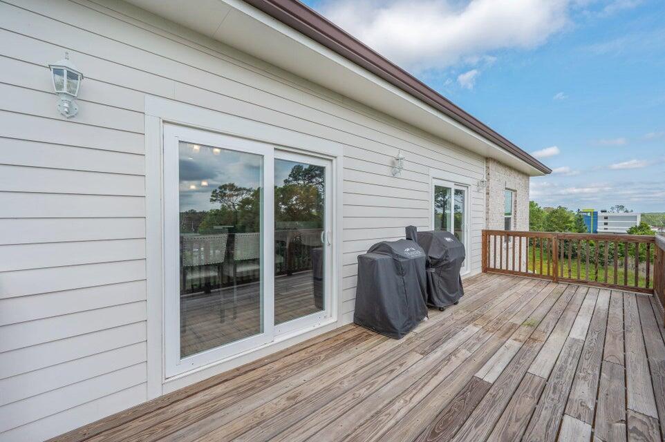 508 Harborview Circle Niceville, FL 32578 - Photo 36 of 60 a view of a deck with wooden floor and floor to ceiling window